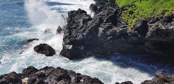 Waves splashing on rocks at shore