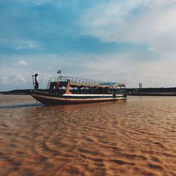 Boat on lake against sky