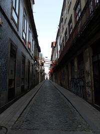 Street amidst city against clear sky