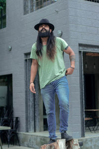 Portrait of man wearing sunglasses standing against built structure