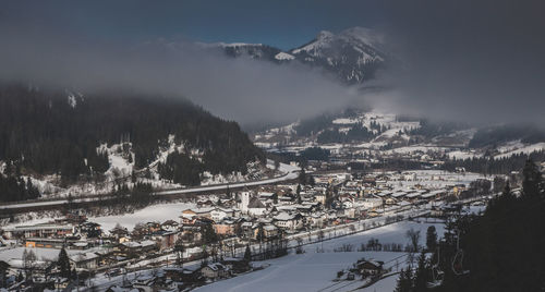 High angle view of snowcapped mountains during winter and town