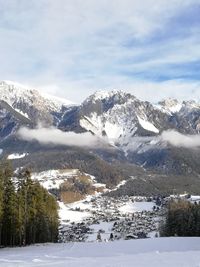 Scenic view of snow covered mountains against sky