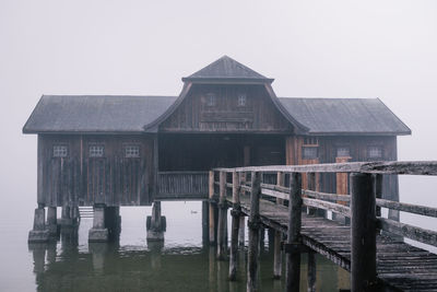 Exterior of building by sea against clear sky