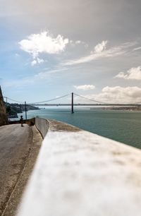 Surface level of bridge over sea against sky