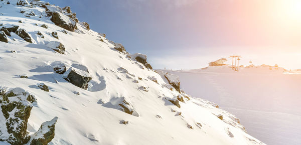 Scenic view of snow covered mountains against sky