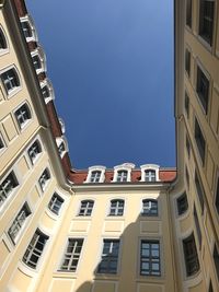 Low angle view of buildings against blue sky