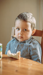 Portrait of cute baby boy sitting on table