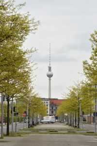 View of communications tower in city against sky