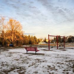 Scenic view of snow covered field against sky