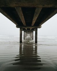 Pier over sea against clear sky