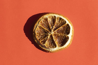 A slice of dried orange with a hard shade