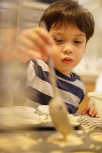 Portrait of cute boy holding table