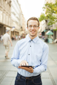 Portrait of young man standing on street