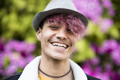 Portrait of smiling man wearing hat against blurred background