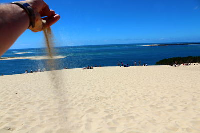 People on beach against sky