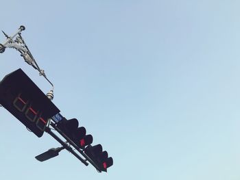 Low angle view of road signal against clear sky