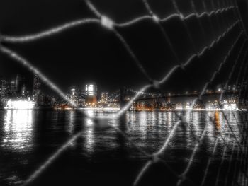 Suspension bridge over river at night