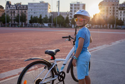 Portrait of woman riding bicycle on street