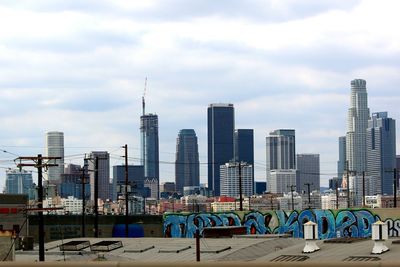 City skyline against cloudy sky