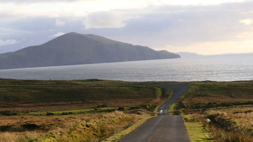 Road by sea against sky