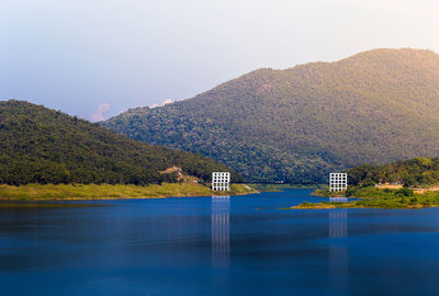 Scenic view of lake and mountains against clear sky