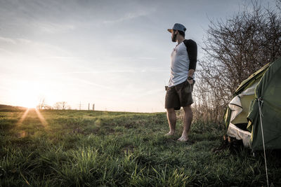 Man standing on field against sky