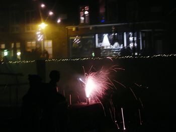 Crowd at illuminated music concert at night