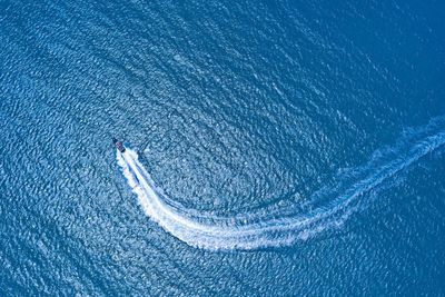 Aerial view of boat sailing on sea