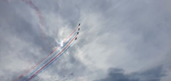 Low angle view of airplane flying against sky