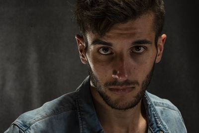 Portrait of young man against wall