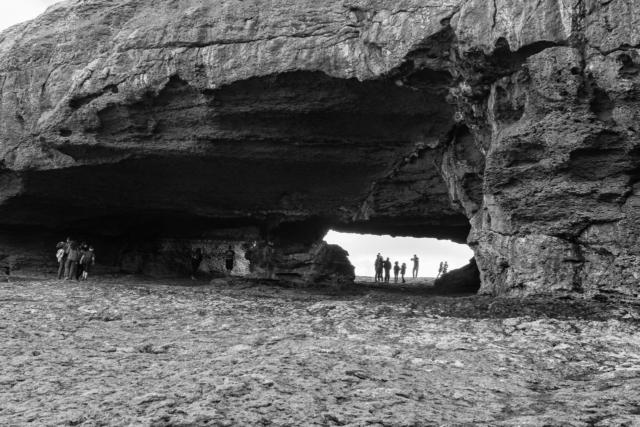 GROUP OF PEOPLE ON ROCK FORMATION