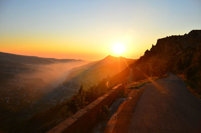 Scenic view of mountain road during sunset