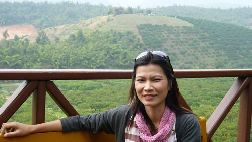 Portrait of smiling mature woman standing at observation point