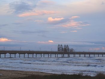 Pier on sea at sunset