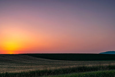 Scenic view of field against sky during sunset