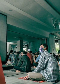 Rear view of people sitting on stage