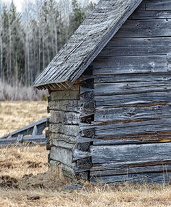 Old wooden house on field