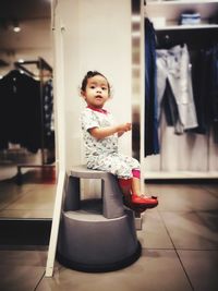 Portrait of smiling girl standing on floor at home