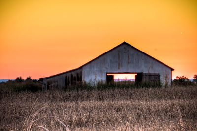 Abandoned barn against sky during sunset