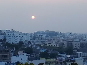 Aerial view of buildings in city against sky