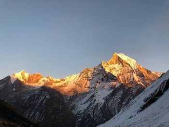 Scenic view of snowcapped mountains against clear sky