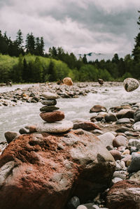 Stones on rock against sky