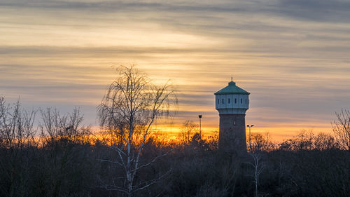 Silhouette buildings against sky during sunset