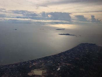 High angle view of buildings by sea against sky