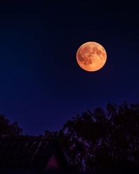 Low angle view of moon against clear sky at night