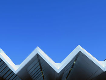 Low angle view of building against clear blue sky