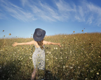 Woman holding plant in field