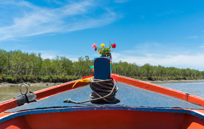 View of red boat against blue sky