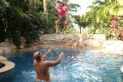 Man jumping in swimming pool