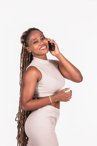 Portrait of a smiling young woman against white background